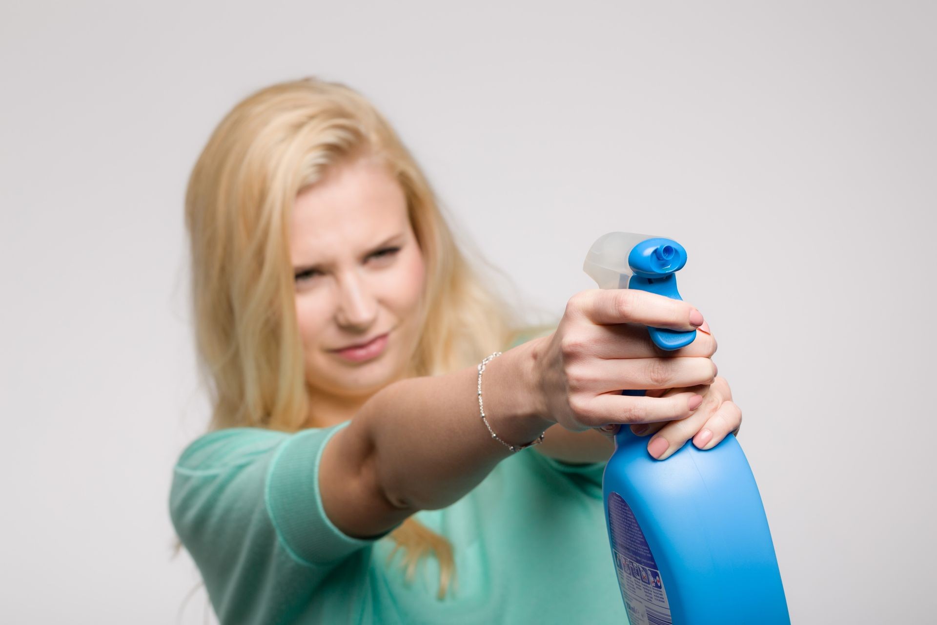 young woman with cleaner spray